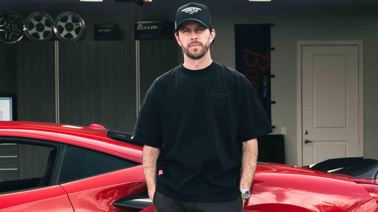 TJ Hunt standing in front of a red sports car