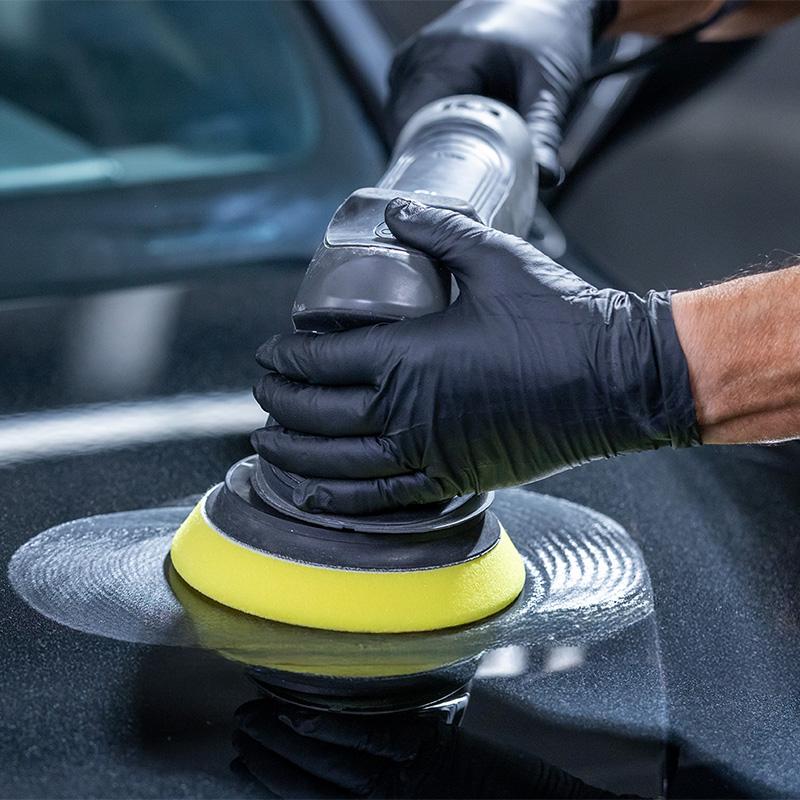 Person using a DA buffer on a car hood