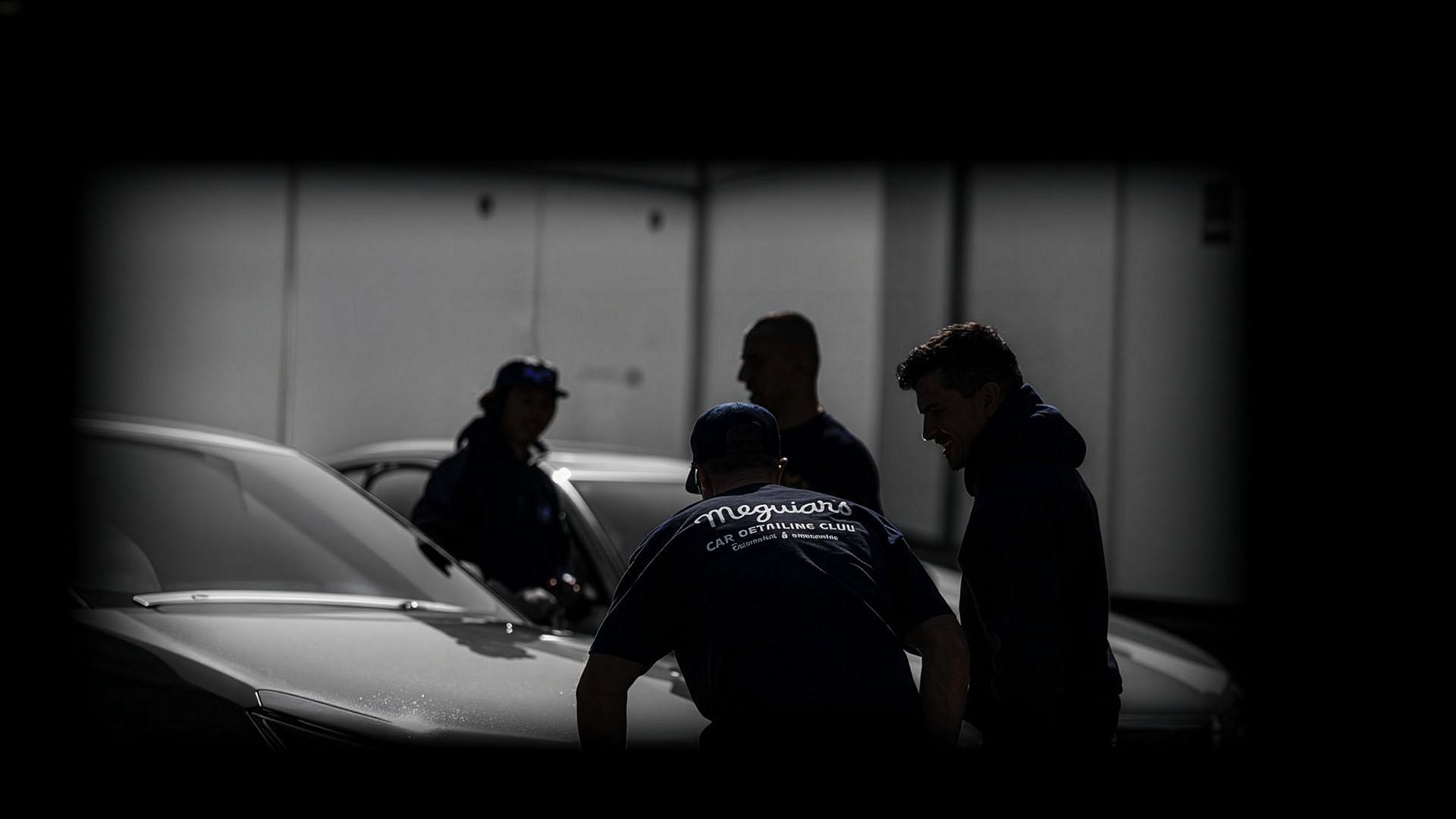 Shadowy figures detailing cars